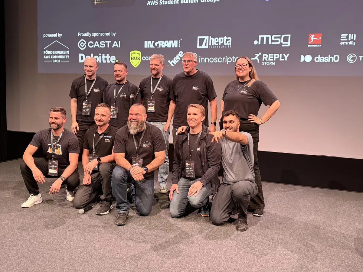 The volunteer organizing team of AWS Community Day DACH on stage in matching Förderverein AWS Community DACH shirts